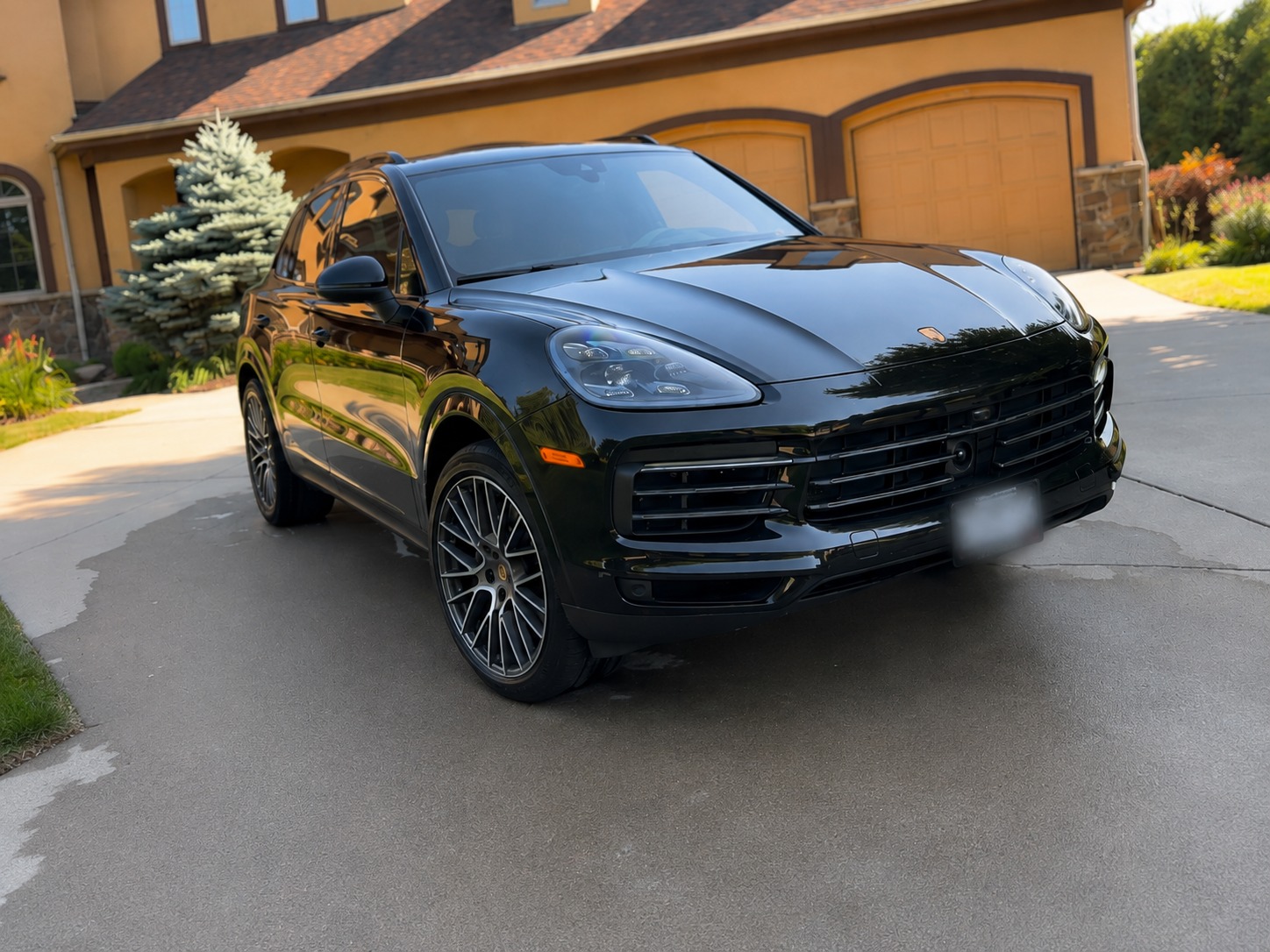 Detailed black Porsche Cayenne in a driveway